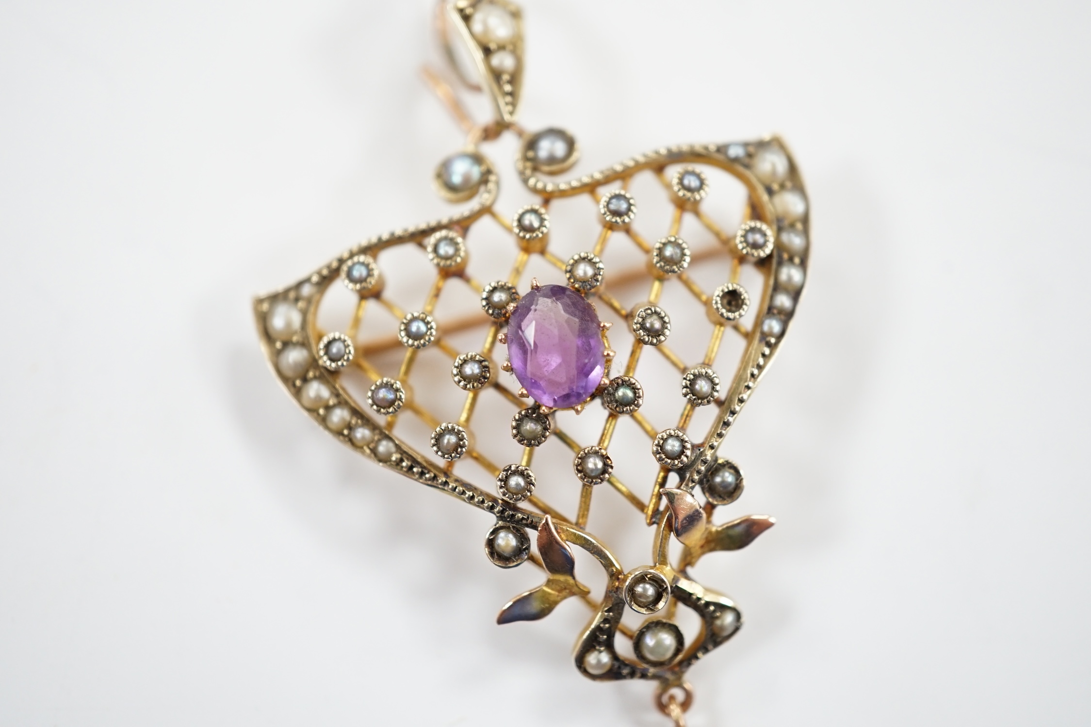 An Edwardian Art Nouveau 9ct, amethyst and seed pearl set drop pendant, 50mm, gross weight 5.2 grams.